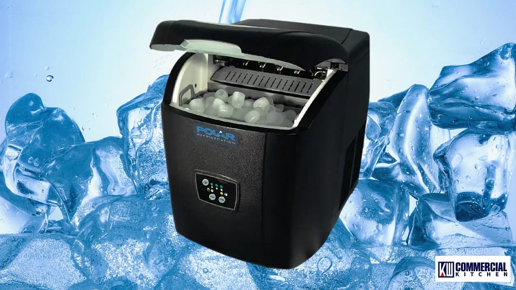 Compact self‑contained ice maker with lid open producing bullet‑style ice, on a pile‑of‑ice background.