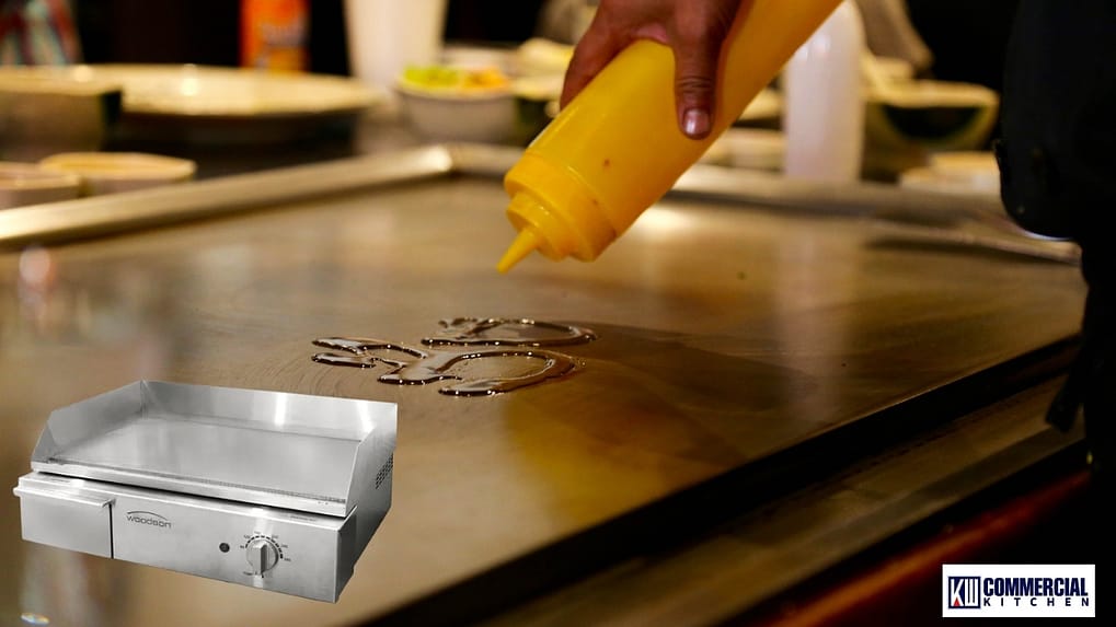 Chef using a cloche to finish a smash burger on a commercial griddle