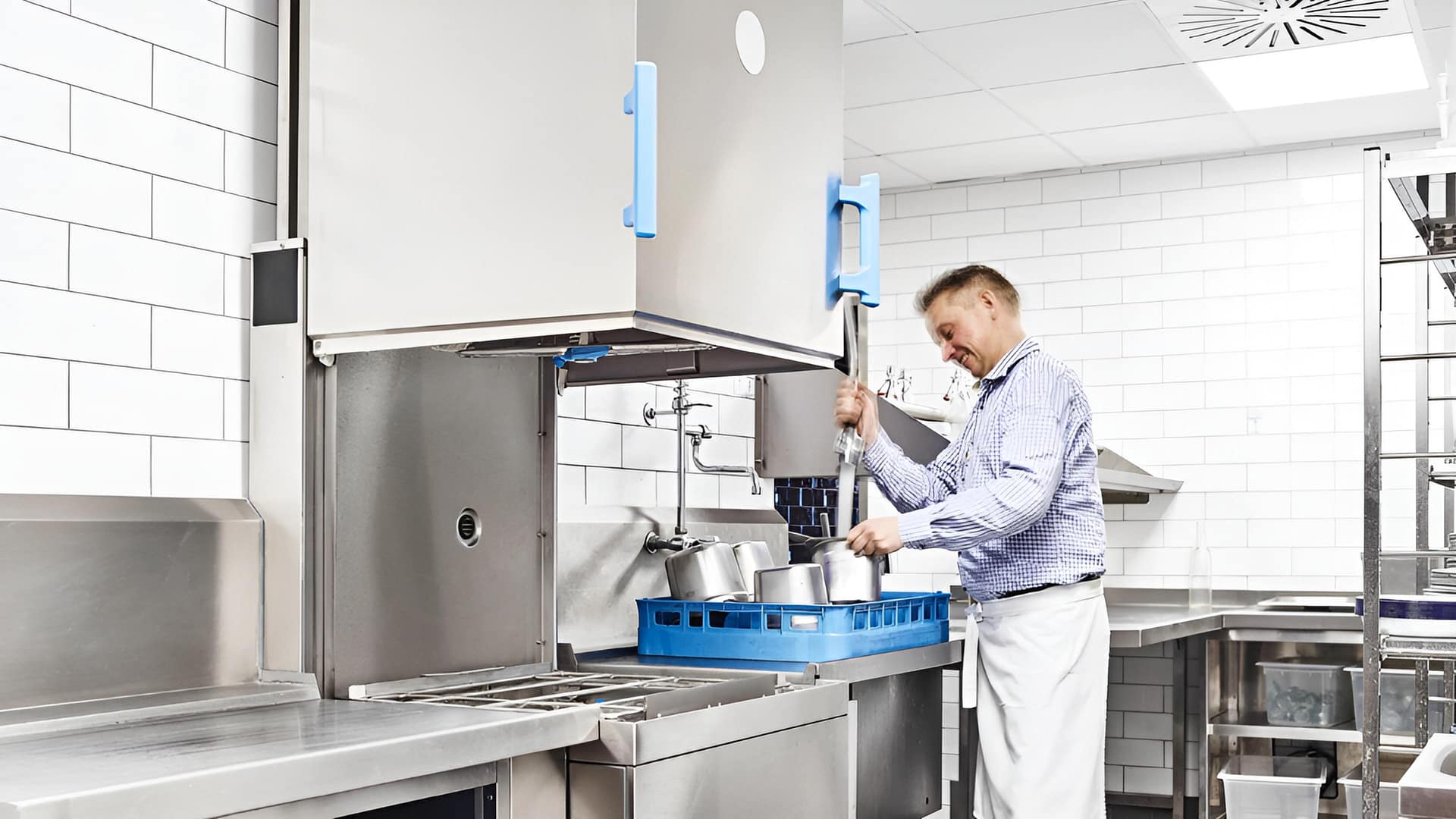 commercial r dishwasher installed at back‑bar with pre‑rinse, drain upstand and accessible isolation